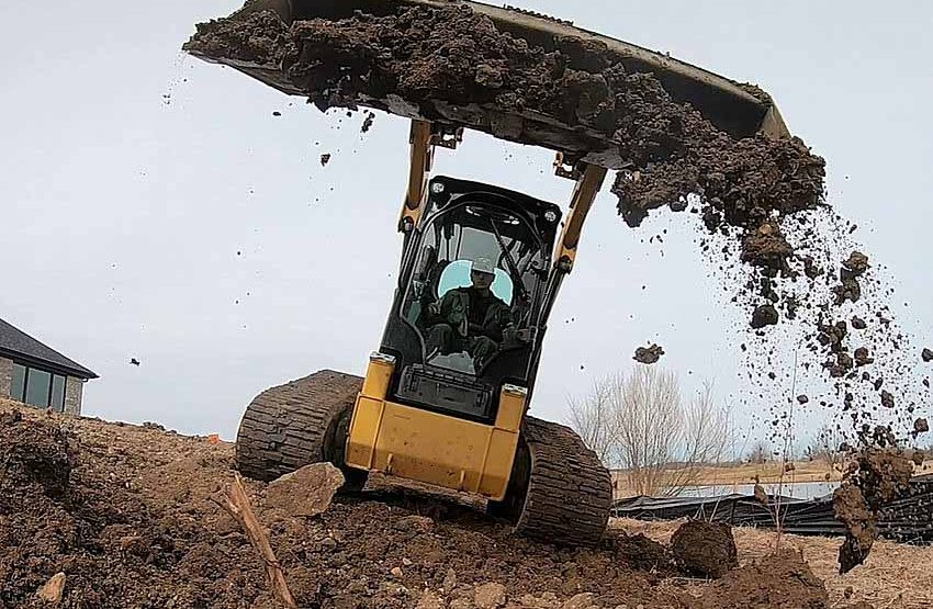 A skilled professional in an excavator, digging up land area in preparation for a construction project